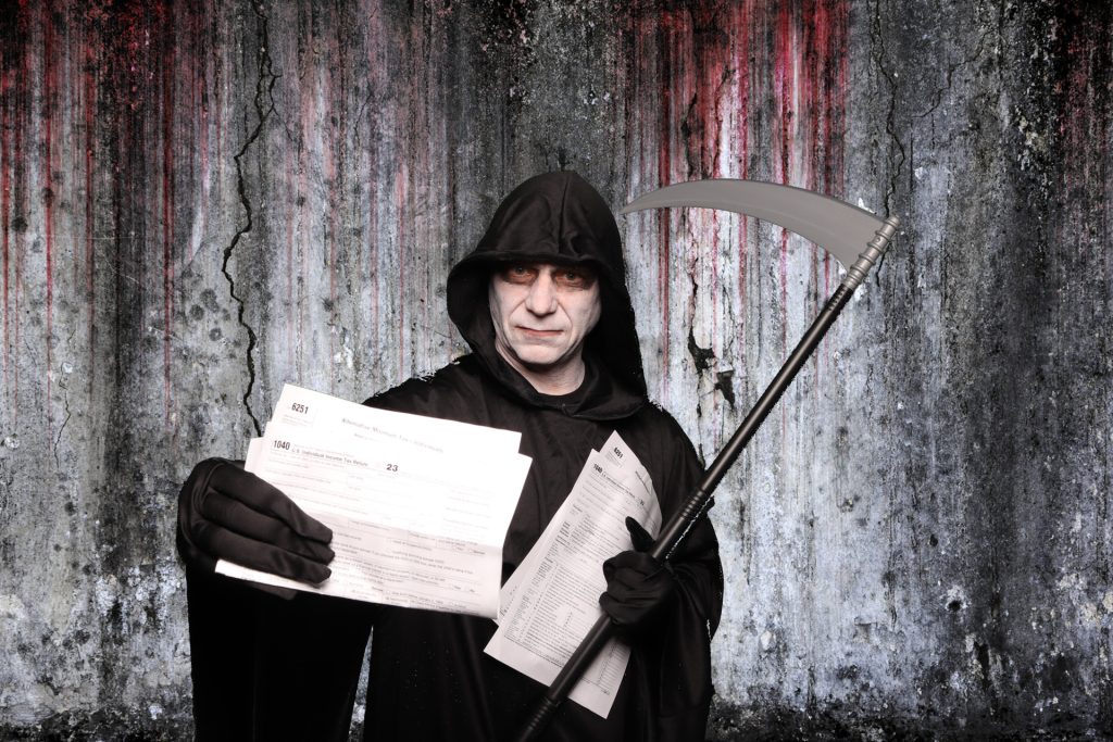 Man dressed in costume taking a photo in front of a greenscreen Halloween Photo Booth.