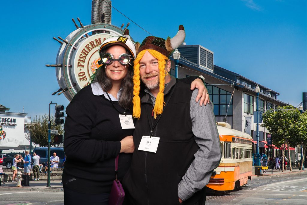 Couple poses for a photo in front of a greenscreen San Francisco Photo Booth.