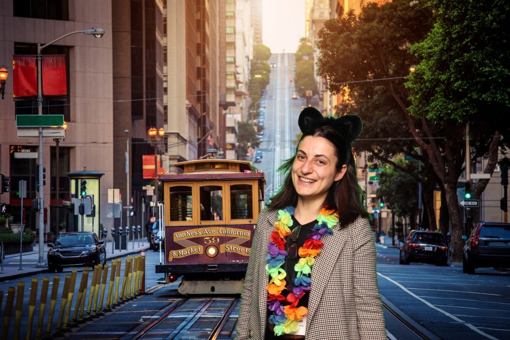 Woman poses for a photo in front of a greenscreen San Francisco Photo Booth.