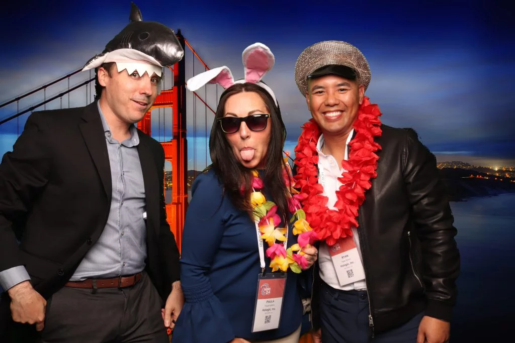 Group poses for a photo in front of a greenscreen San Francisco Photo Booth.