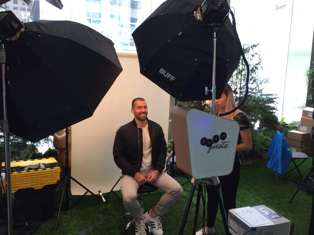 Man takes a corporate headshot using the Mobile Headshot Studio.