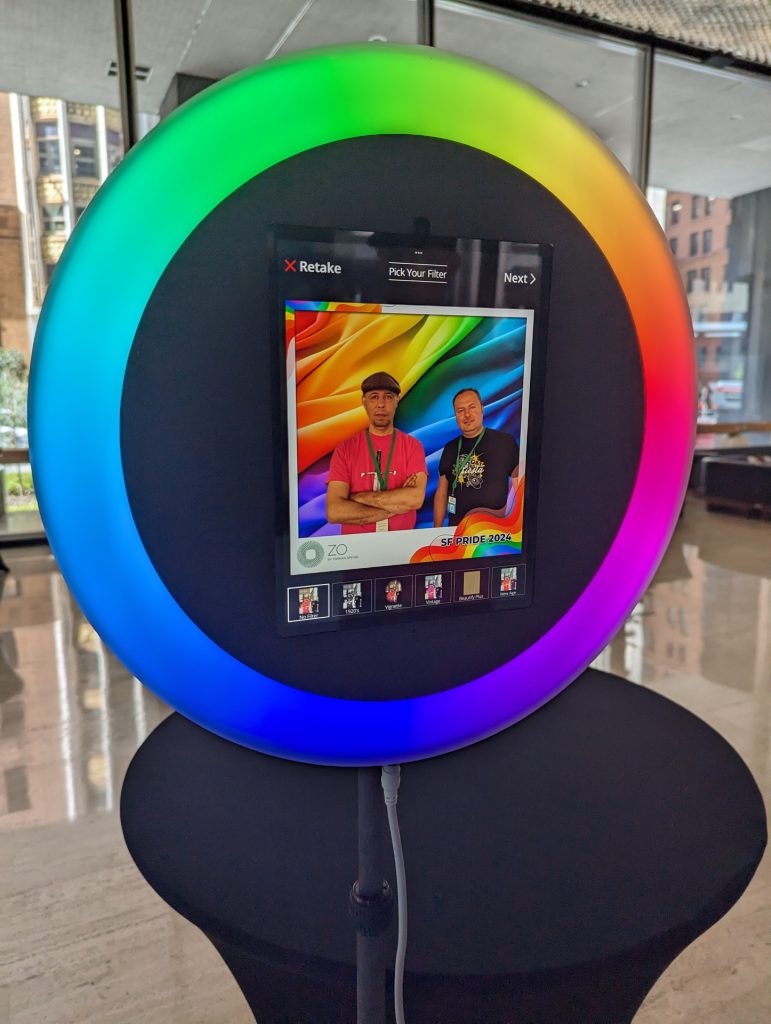 Two men standing in front of an AI Photo Booth.