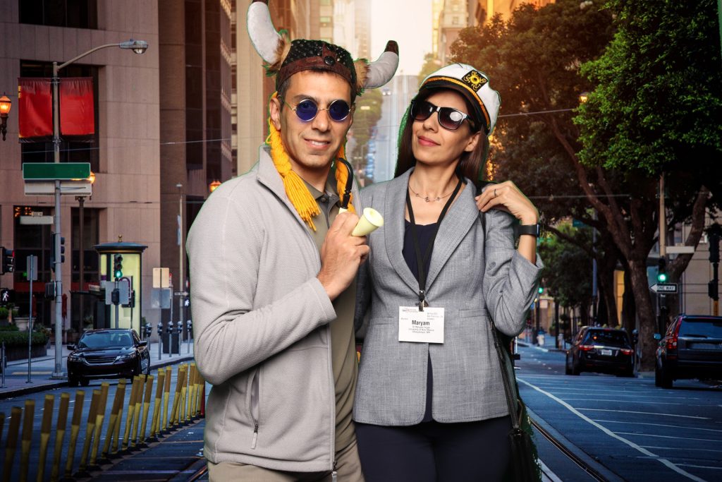Couple poses for a photo in front of a greenscreen San Francisco Photo Booth.