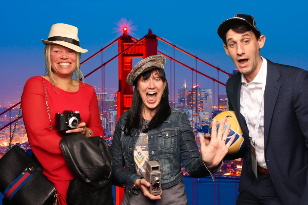 Group poses for a photo in front of a greenscreen San Francisco Photo Booth.