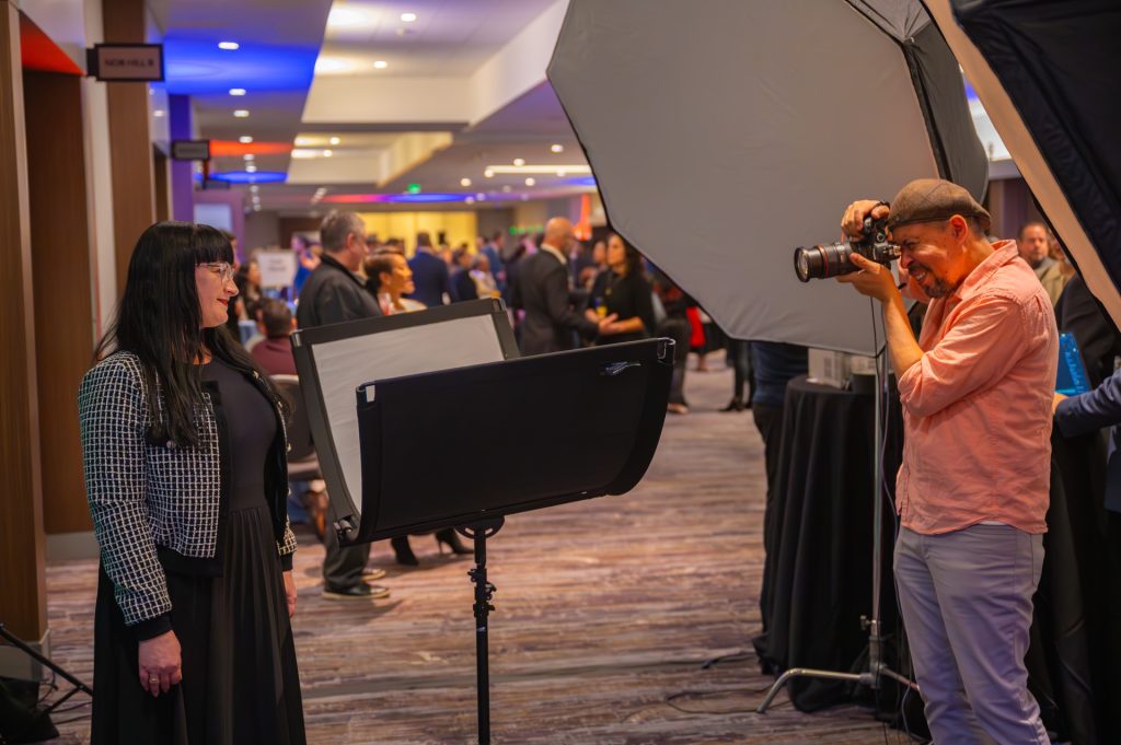 A woman getting her headshot clicked from a professional photographer at an event in San Francisco.