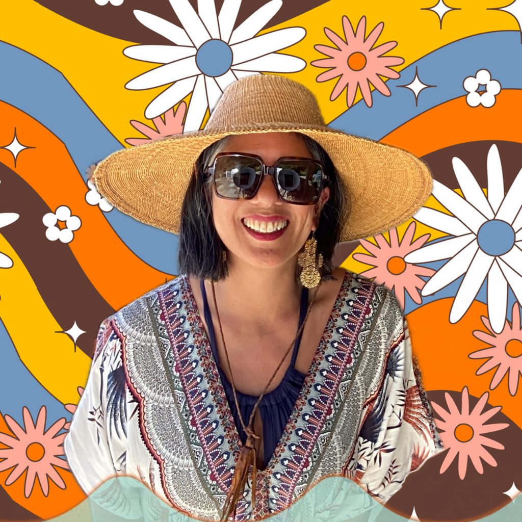 woman wearing a hat in front of a floral hippie background