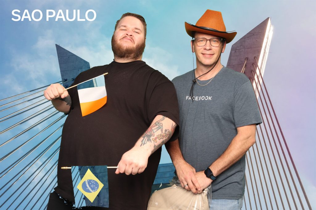 two men posing for a photo in a greenscreen photo booth