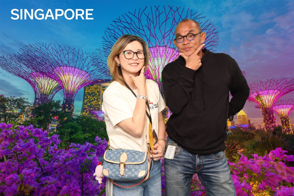 Man and a woman posing for a photo in a greenscreen photo booth