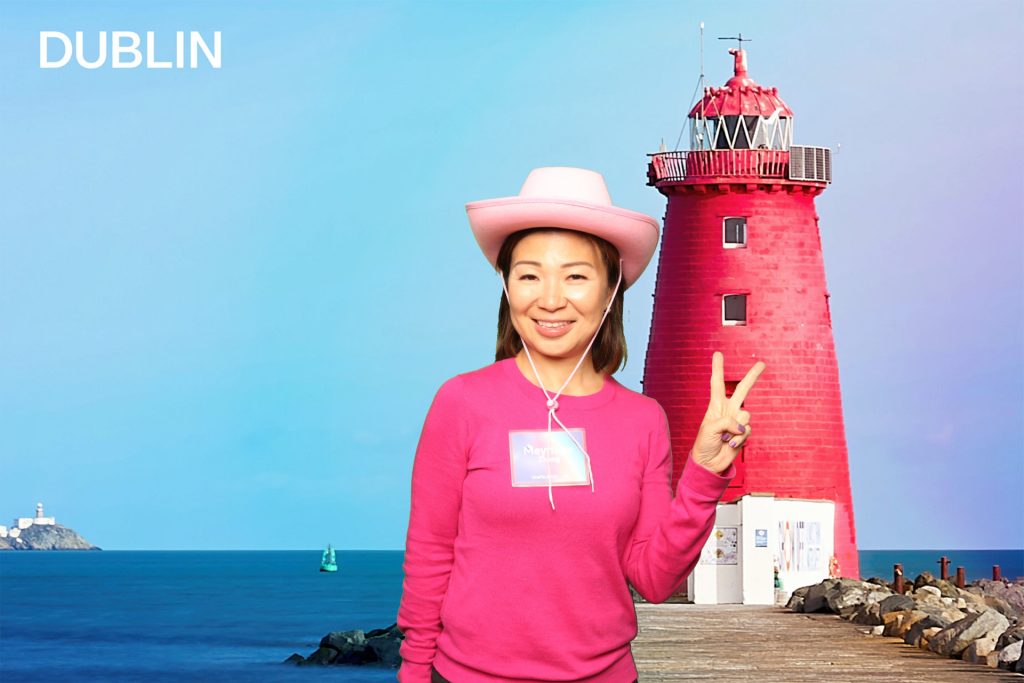 Woman posing for a photo in a greenscreen photo booth