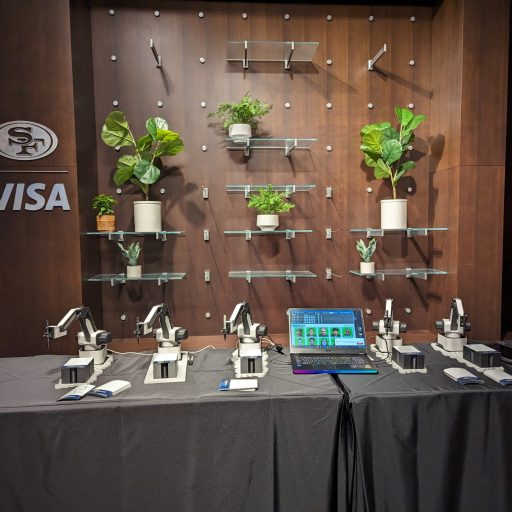 Image of a SketchBot set up with 5 robot arms on a table.