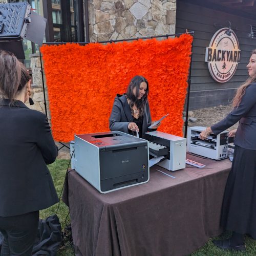 women working at an event printing custom flipbooks
