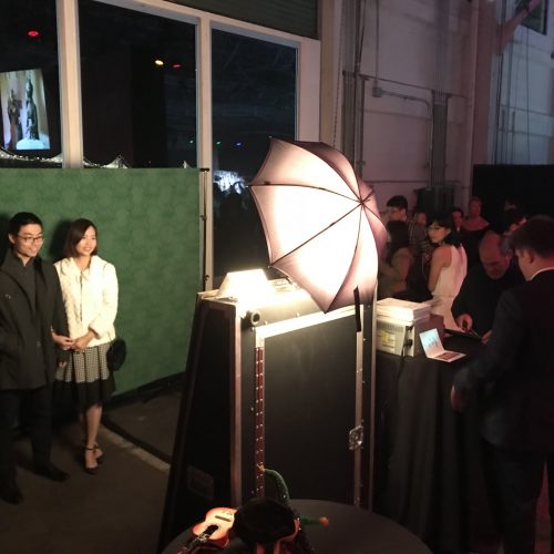a couple posing in a mirror photo booth at an upscale event