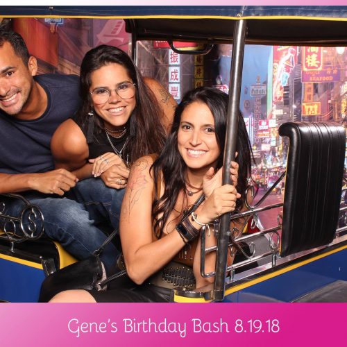 a man and two women smiling in a vehicle photo booth